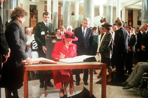 The Queen signing the visitor's book