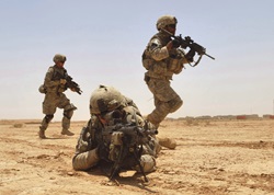 U.S. Army Pfc. Robert Parker, foreground, provides fire support for his squad members during a live-fire exercise at the Kirkush Military Training Base in the Diyala province of Iraq June 27, 2010.