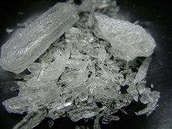A macro shot of Crystal Methamphetamine on a black background