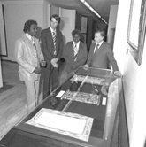 Yolngu leaders Gallarwuy Yunupingu (left) and Silas Roberts at Parliament House in 1977 with Jeremy Long and the Minister for Aboriginal Affairs, THE Hon. Ian Viner (right), looking at the two bark petitions presented to the House of Representatives in 1963.
