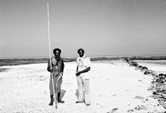 Two Aboriginal men on beach, one with fishing spear [Eddie Mabo (left) and Jack Wailu on the Island of Mer in the Torres Strait Islands] 