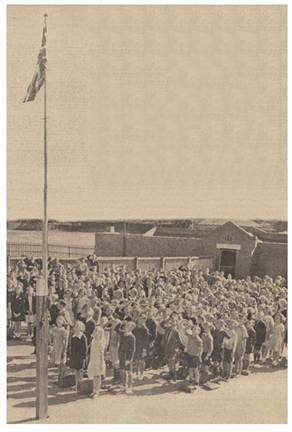 Children of Brighton-rd State School, Melbourne, salute the Union Jack in 1938