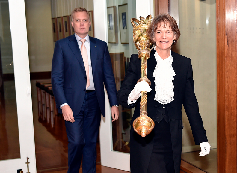 Lynne Everston carrying the Mace and escorting the Speaker from the Chamber.
