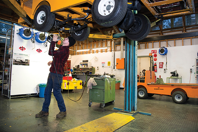 Mechanic Nick Harris services one of the electric carts that transport goods in the basement.