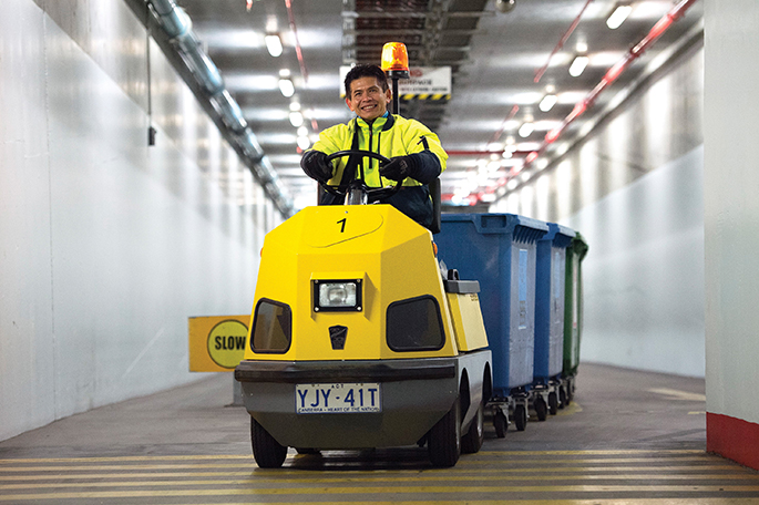 Soukha Phathanak transports recyclable materials in the Parliament House basement.