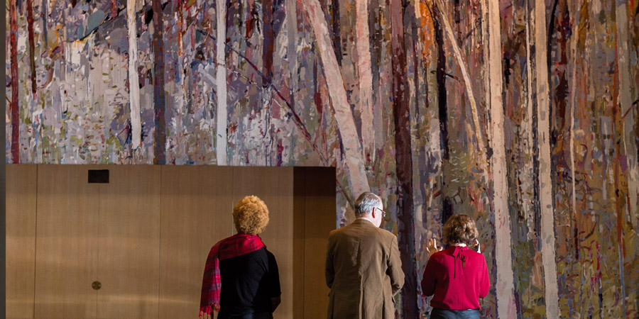 Visitors standing in front of the Great Hall Tapestry