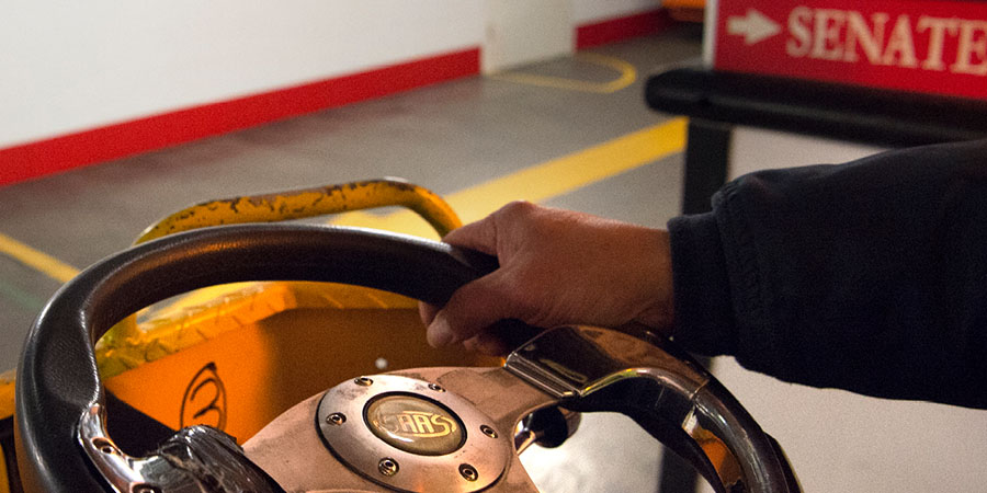 DPS staff member driving a vehicle in the basement of Australian Parliament House
