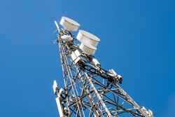 photo of communication and cell tower on blue sky background
