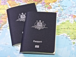 Australian Passport with the world map in the background