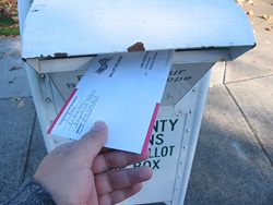 A voter returns his vote-by-mail ballot in the 2006 General elections in Lane County, Oregon.