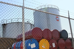 Photograph of stacked barrels of oil