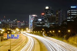 Photo of city at night with busy road 