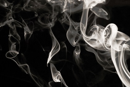 Tobacco smoke against a black background.
