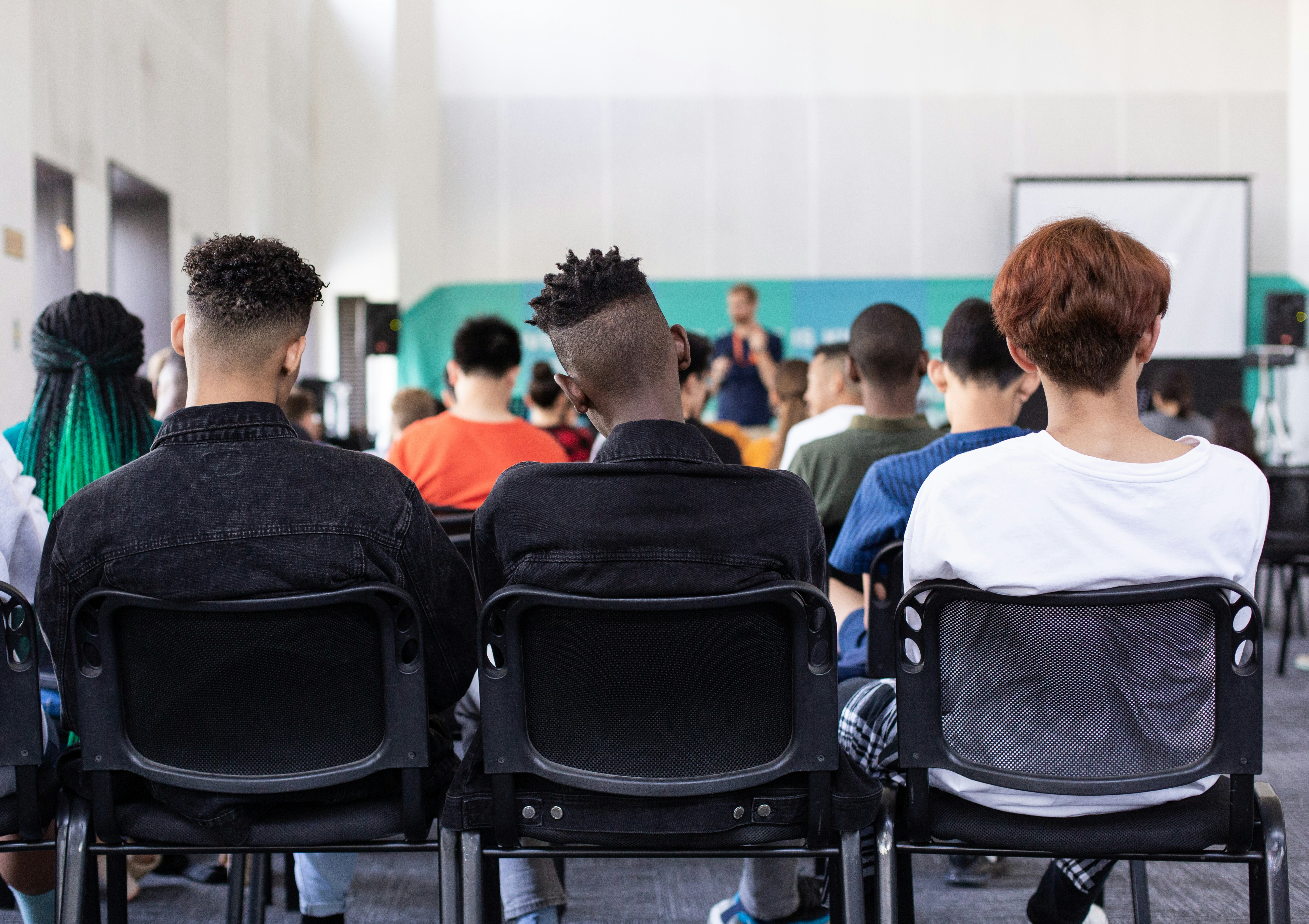 Group of high school students sitting at the back of a classroom
