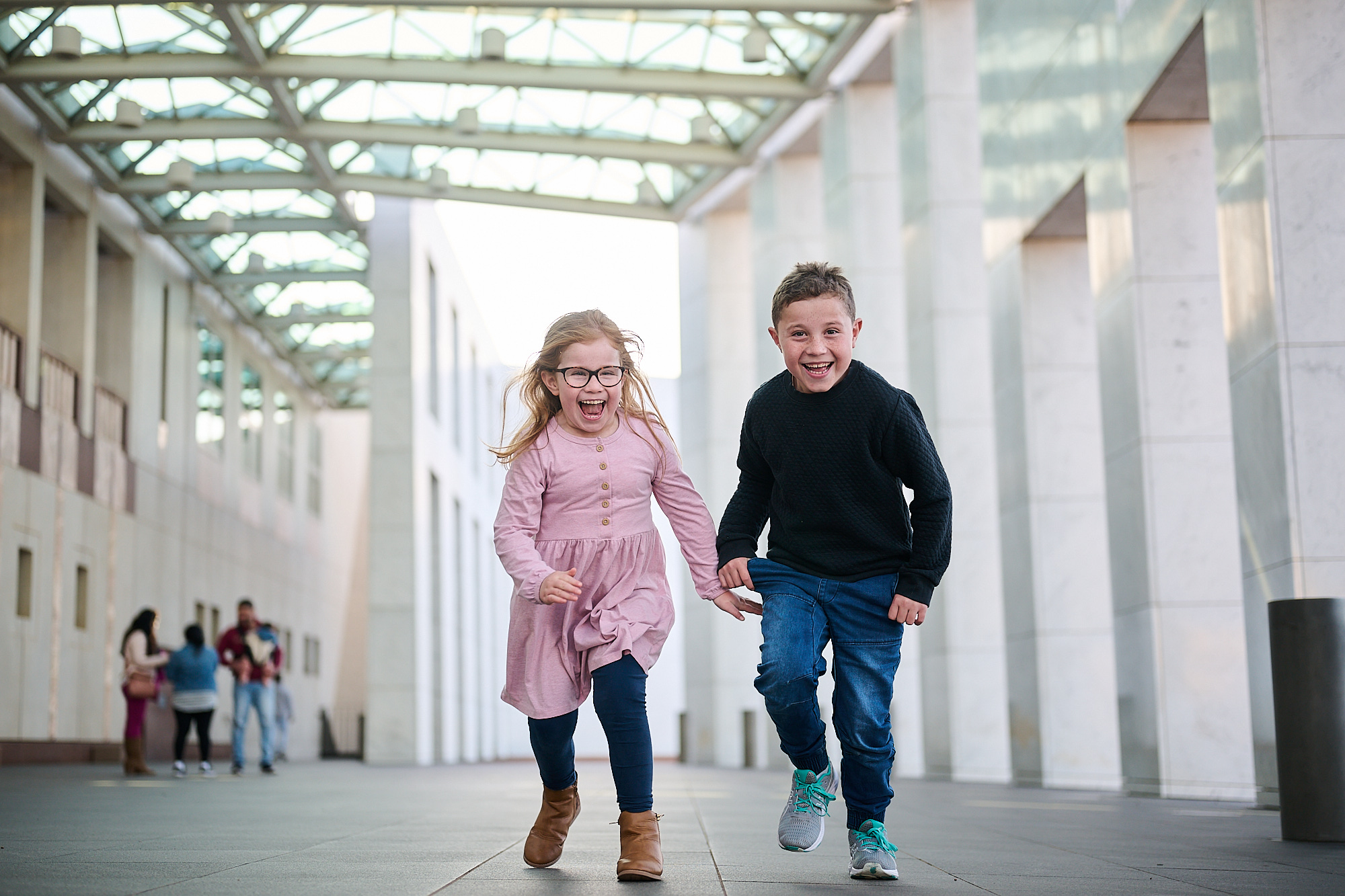Photo of two children playing in front of Parliament House