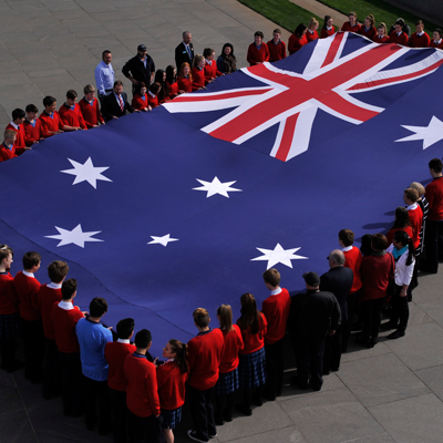 School children holding the Australian flag at Parliament House