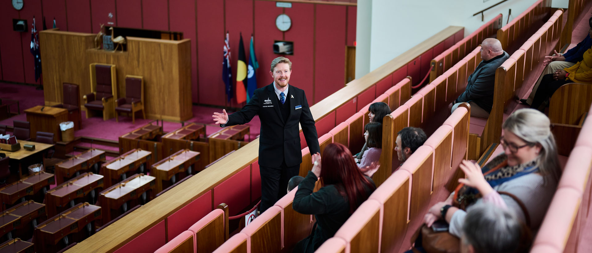A guide shows visitors features of Members Hall at Parliament House
