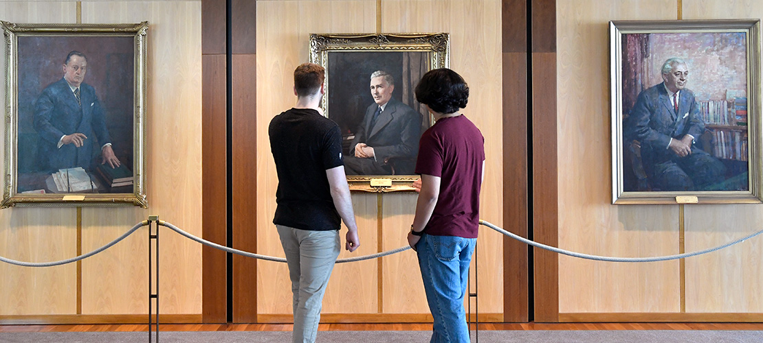 Visitors view the portraits of former prime ministers