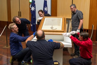 DPS staff install the Magna Carta in the Great Hall of Parliament House for the 800th anniversary event