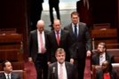 Senators Anning, Bartlett and Steele-John are escorted to the Senate table to take their oaths of office.