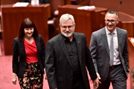 Senators Anning, Bartlett and Steele-John are escorted to the Senate table to take their oaths of office.