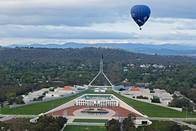 A hot air balloon flying over Parliament House