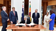 Sri Lankan Prime Minister Ranil Wickremesinghe signs the visitors’ book at Parliament House