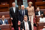 Slade Brockman is escorted into the Senate chamber to take the oath of office by fellow Western Australian Liberal senators Mathias Cormann and Michaelia Cash.