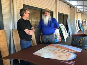 Figure 1.6 & 1.7 (from left to right); Senator Dodson speaks to the manager of the Yarliyil Arts Centre about the centre's current community project; and photo of some of the artworks which will be placed around Halls Creek. 