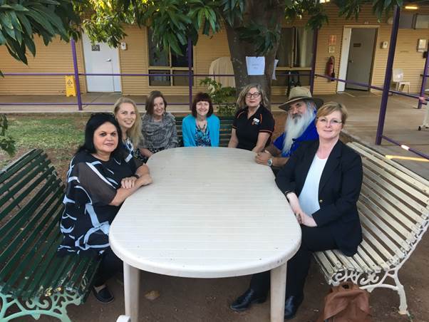 Figure 1.8: Photo of Senator Siewert, Senator Dodson, Senator Reynolds and Secretariat staff, Ms Jeanette Radcliffe and Ms Amelia Hurd with Facility Manager, Ms Patricia Williams, and TAFE Lecturer, Ms Loretta Andrew, seated in a communal area at Halls Creek ACF.