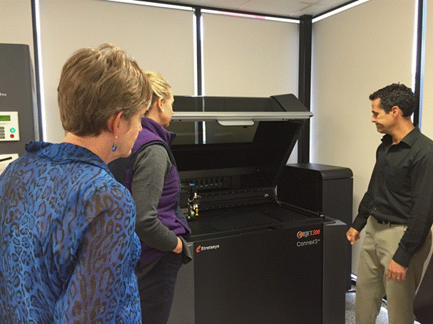 Figure 3.1: Committee members inspect a 3D printer