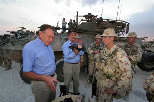 Figure 5.2 Mr Barry Haase MP and the Hon Bruce Scott MP are briefed on the equipment used by the AMTG at Camp Smitty in southern Iraq